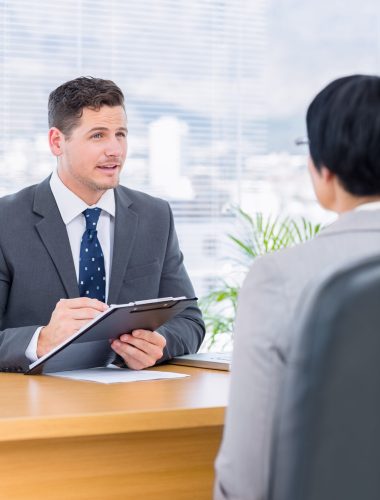 Male recruiter checking the candidate during a job interview at office